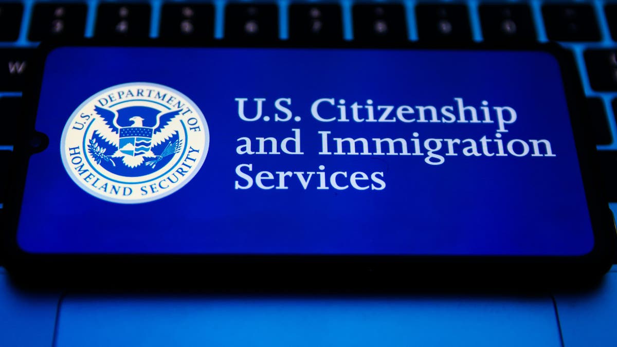 U.S. Citizenship and Immigration Services seal is displayed on a mobile phone screen for illustration photo. Krakow, Poland on February 2nd, 2023.