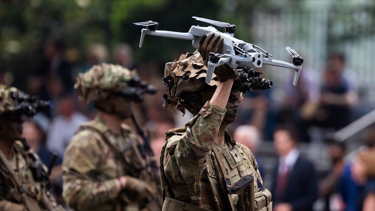 A soldier holds a drone in the U.S. Army's 250th anniversary parade