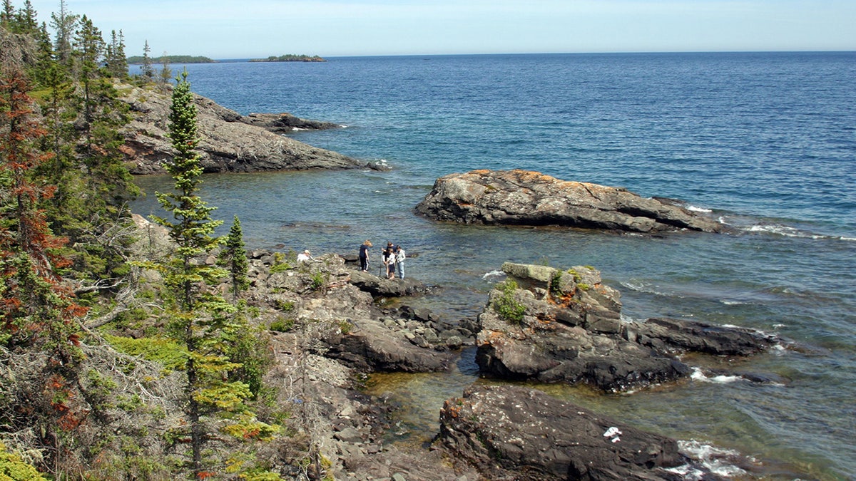 Campers standing on rocks at Isle Royale National Park