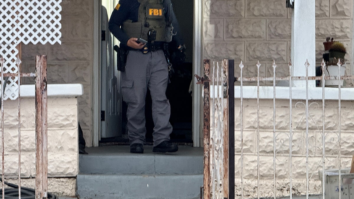 FBI agent stands in home doorway