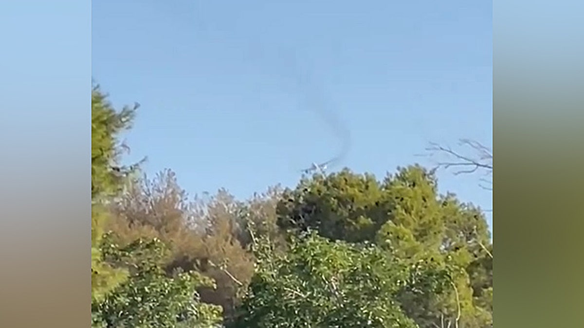 Dark smoke billowed from an airplane as it passed by the Las Vegas National Golf Course on June 25, 2025.