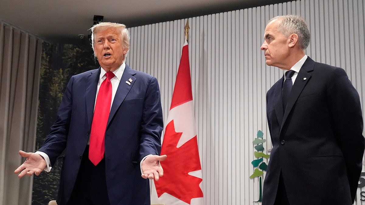 Trump gestures to reporters while Carney listens at G-7 summit press conference