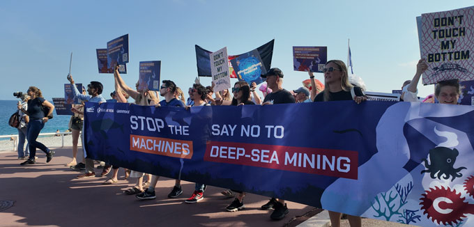A photograph of protestors against deep sea mining ahead of a United Nations oceans conference in Nice, France.