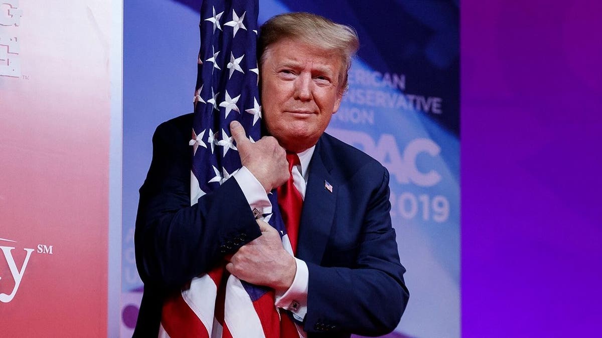 President Donald Trump has hugged the American flag at various points across his political career, including in 2019 during CPAC.
