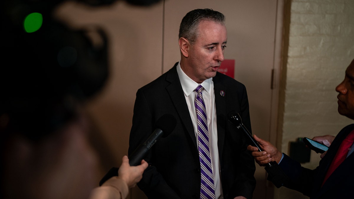 Rep. Brian Fitzpatrick chats with reporters while arriving for a House Republican conference meeting on Capitol Hill on March, 6 2024, in Washington.