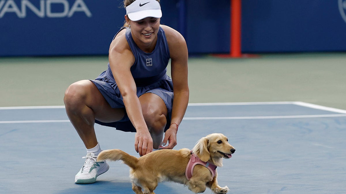 Anna Kalinskaya pets her dog Bella