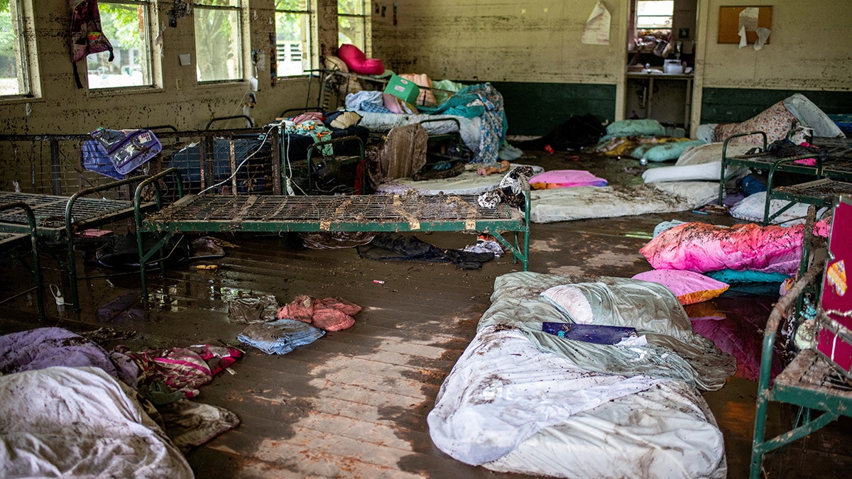 Debris and damage inside of a cabin at Camp Mystic