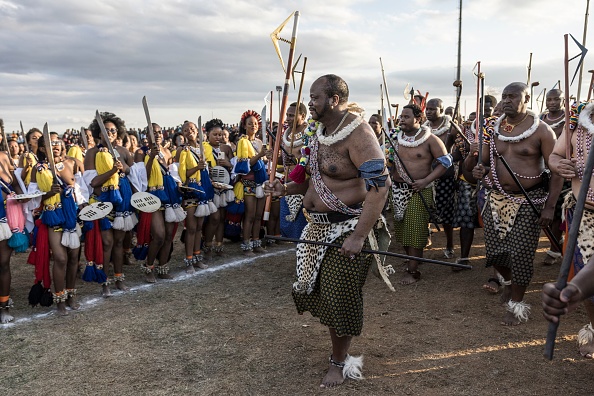 Eswatini's King Mswati III (C) reviews the Swati maidens holding reeds the 2023 Umhlanga Reed Dance ceremony, at the Mbangweni Royal Residence on October 14, 2023. (Photo by MARCO LONGARI / AFP)