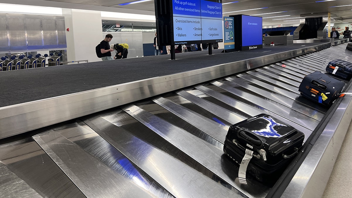 Newark Airport baggage claim conveyor belt with suitcases