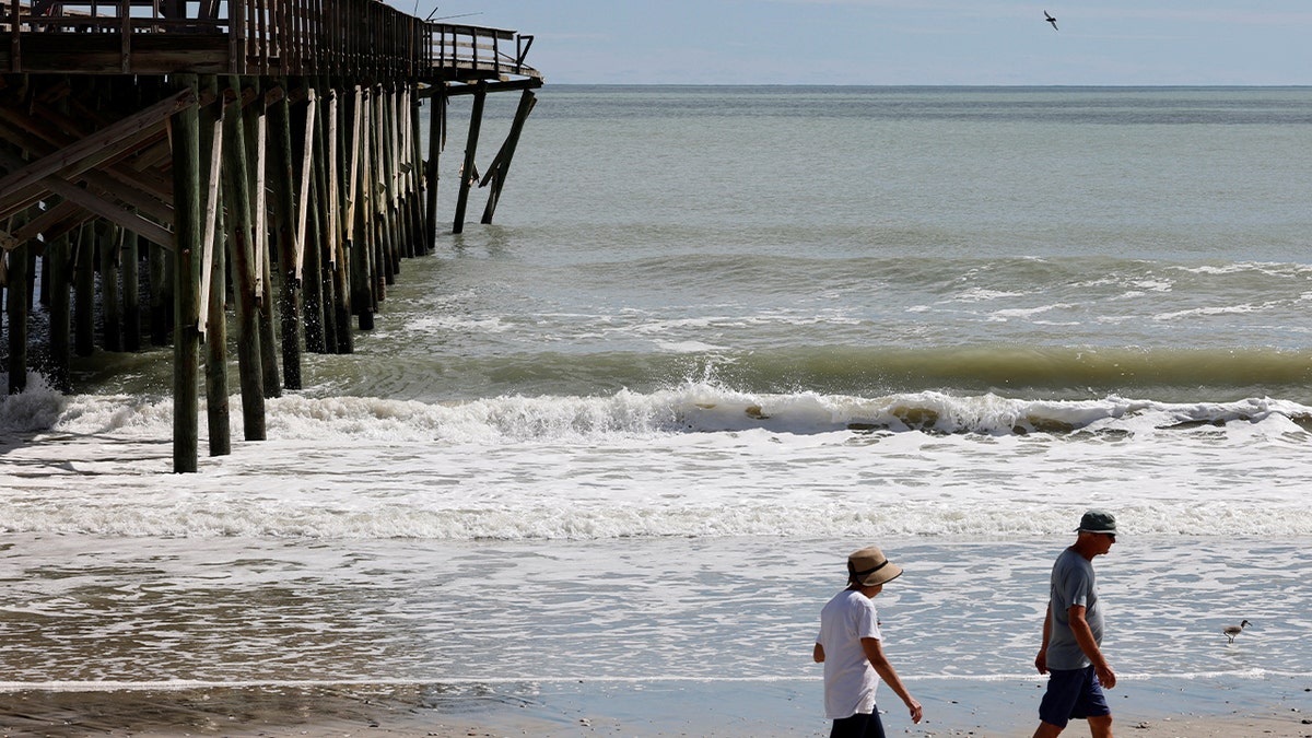 People walk on beach on Pawleys Island