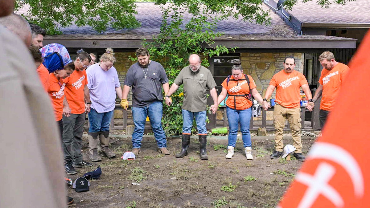 Samaritan's Purse volunteers pray at a work site