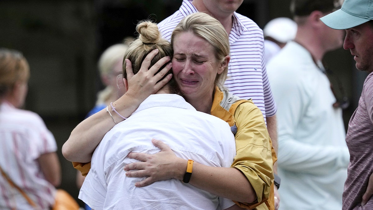 Two people embrace at Texas reunification center after devastating flood