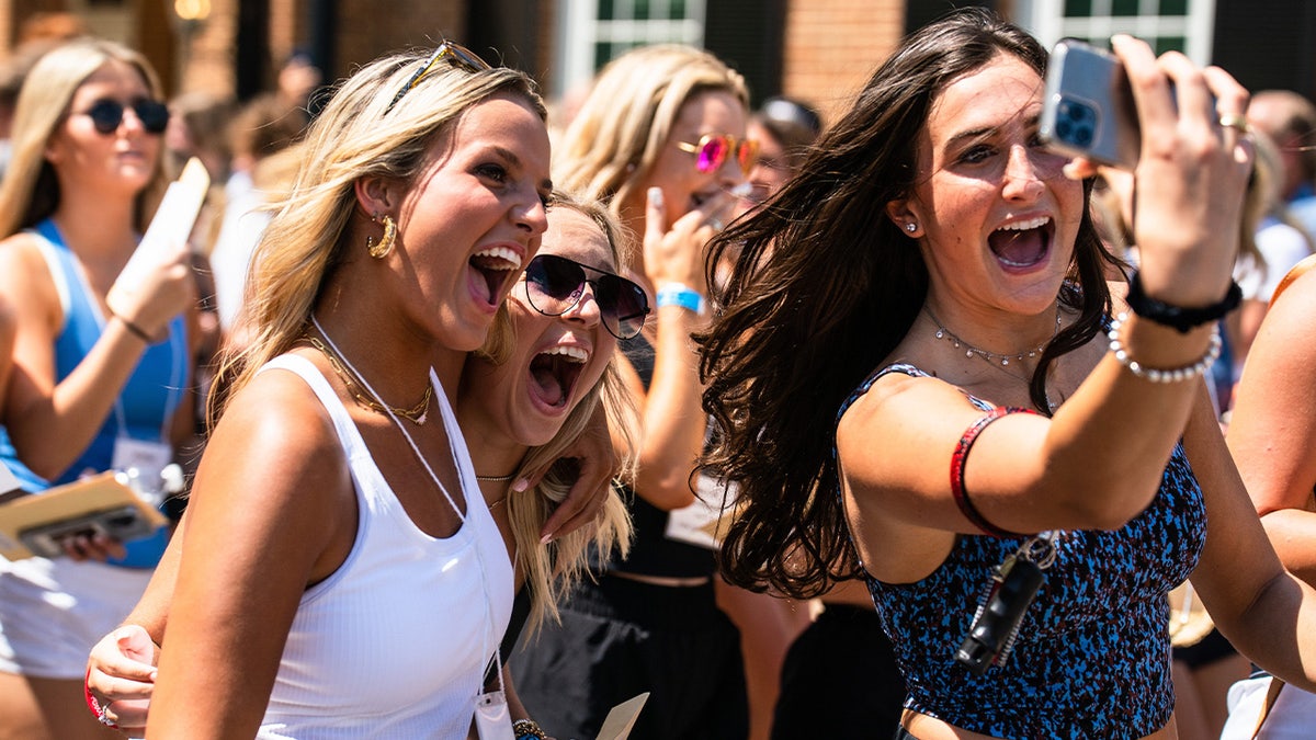 New members take a photo together on bid day 2024.