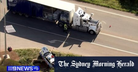 Two cops hospitalised after car collides with semi-trailer