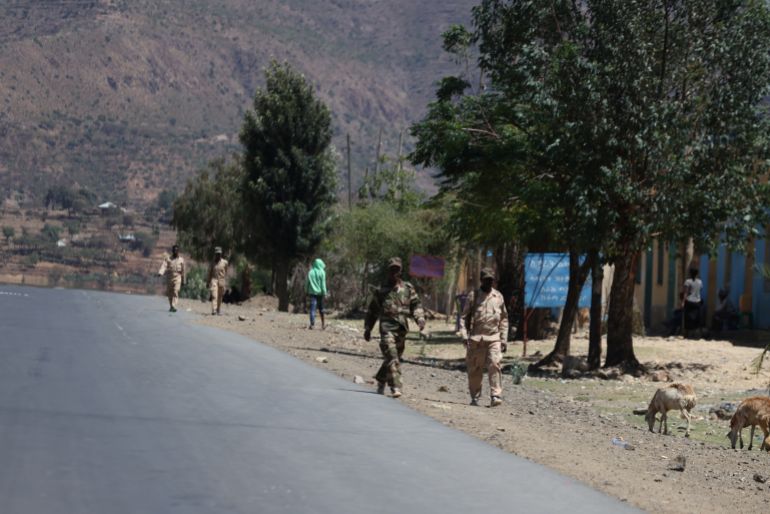 Eritrean troops walk on a road in the Adigrat part of Ethiopia