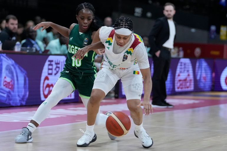 Senegal's Cierra Dillard, right, and Nigeria's Promise Amukamara chase a loose ball during a Women's Olympic Qualifying group A basketball match