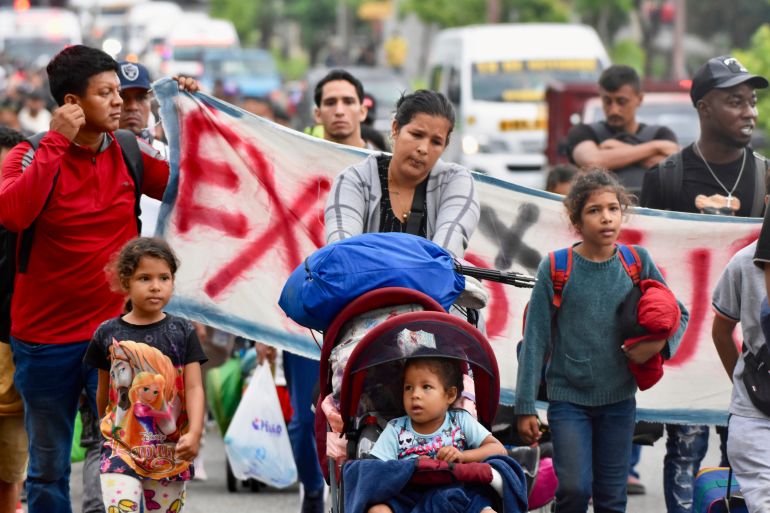 Mothers push strollers as part of a migrant march north through Mexico.