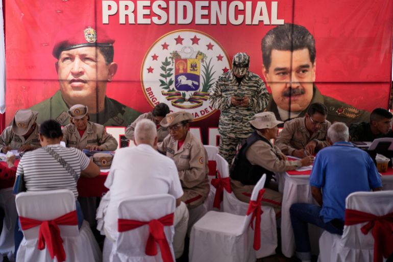 People sign up during a national enlistment drive to join the civil militias, called by the government of President Nicolas Maduro, at a square in Caracas, Venezuela, Saturday, Aug. 23, 2025. (AP Photo/Ariana Cubillos)