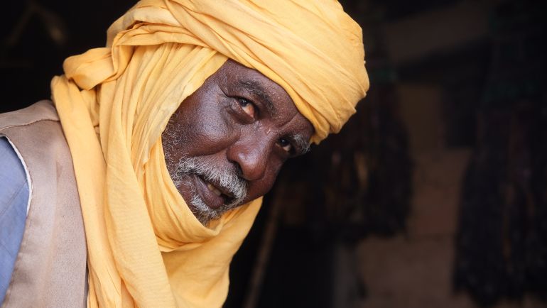 Elhadj Illo bends in his store