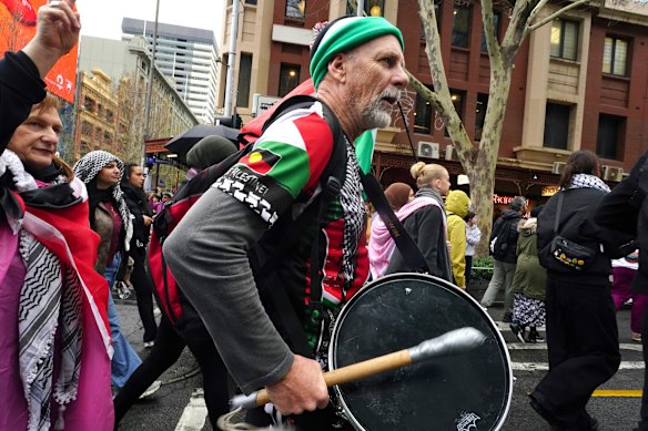 Protesters bang drums on their march towards King’s Bridge.