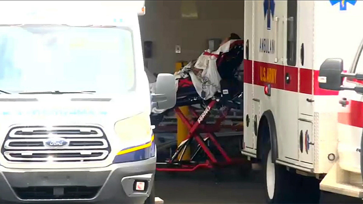 soldier on gurney bed rolled into ER