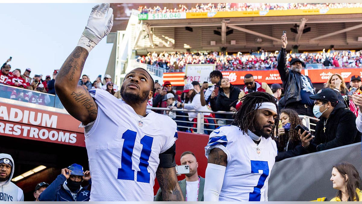 Micah Parsons and Trevon Diggs walk on field