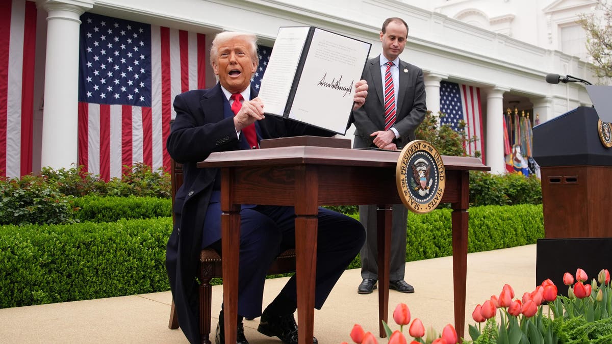 WASHINGTON, DC - APRIL 02: U.S. President Donald Trump displays a signed executive order imposing tariffs on imported goods during a
