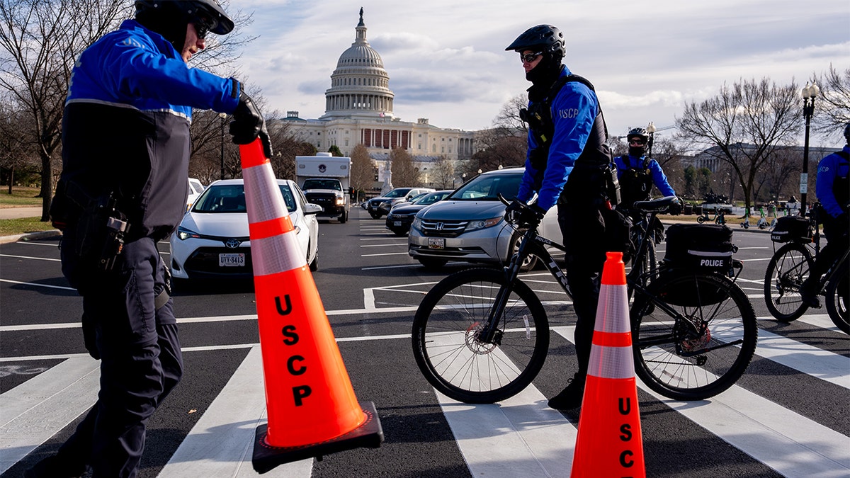  The Dome of the U.S. Capitol Building is visible as U.S. Capitol Police officers reopen a street after a driver was arrested for driving erratically and drove onto the grass near the Capitol Hill 