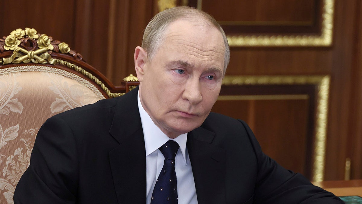 Russian President Vladimir Putin listens during meeting