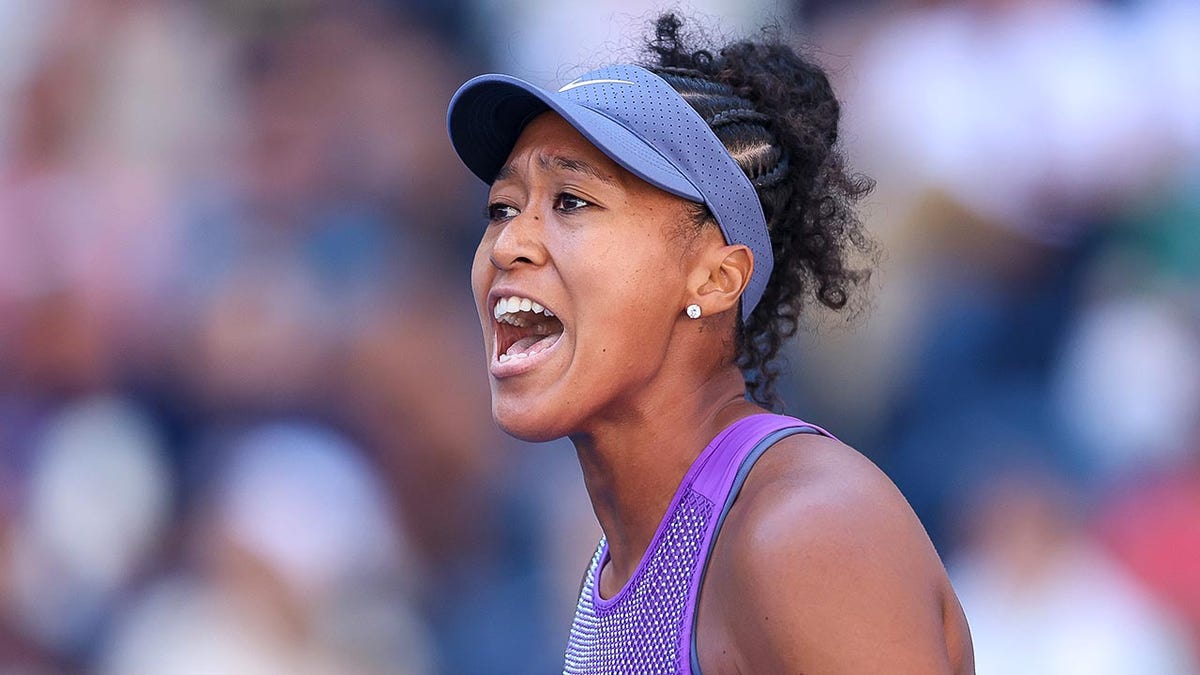Naomi Osaka reacts after point at US Open