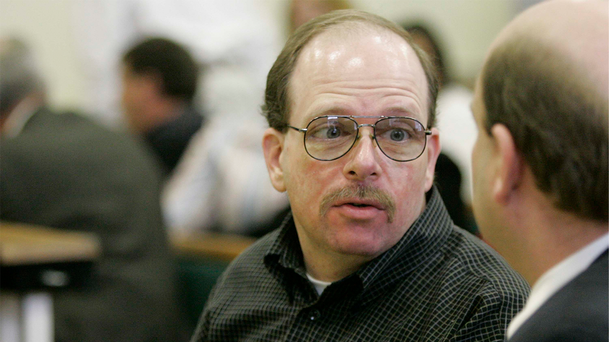 Steven Bixby, left, talks to his public defender, Charles Grose