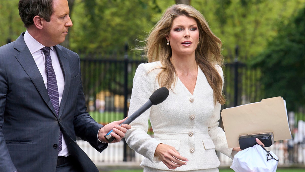 Lindsey Halligan is questioned by reporters as she walks