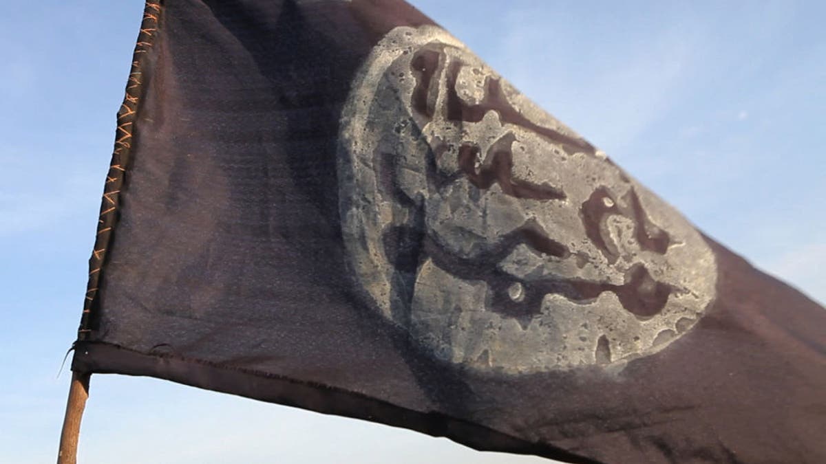 A Boko Haram flag flutters from an abandoned command post in Gamboru deserted after Chadian troops chased jihadists from the border town on February 4, 2015.Â