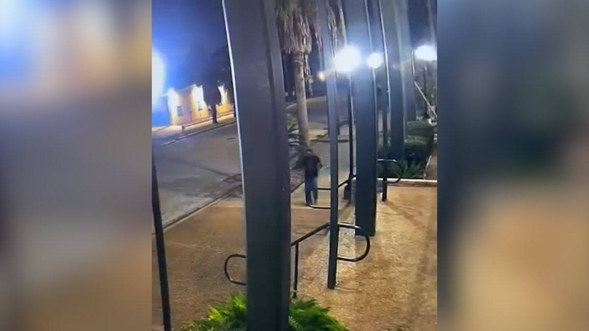 man walks through empty street from a distance