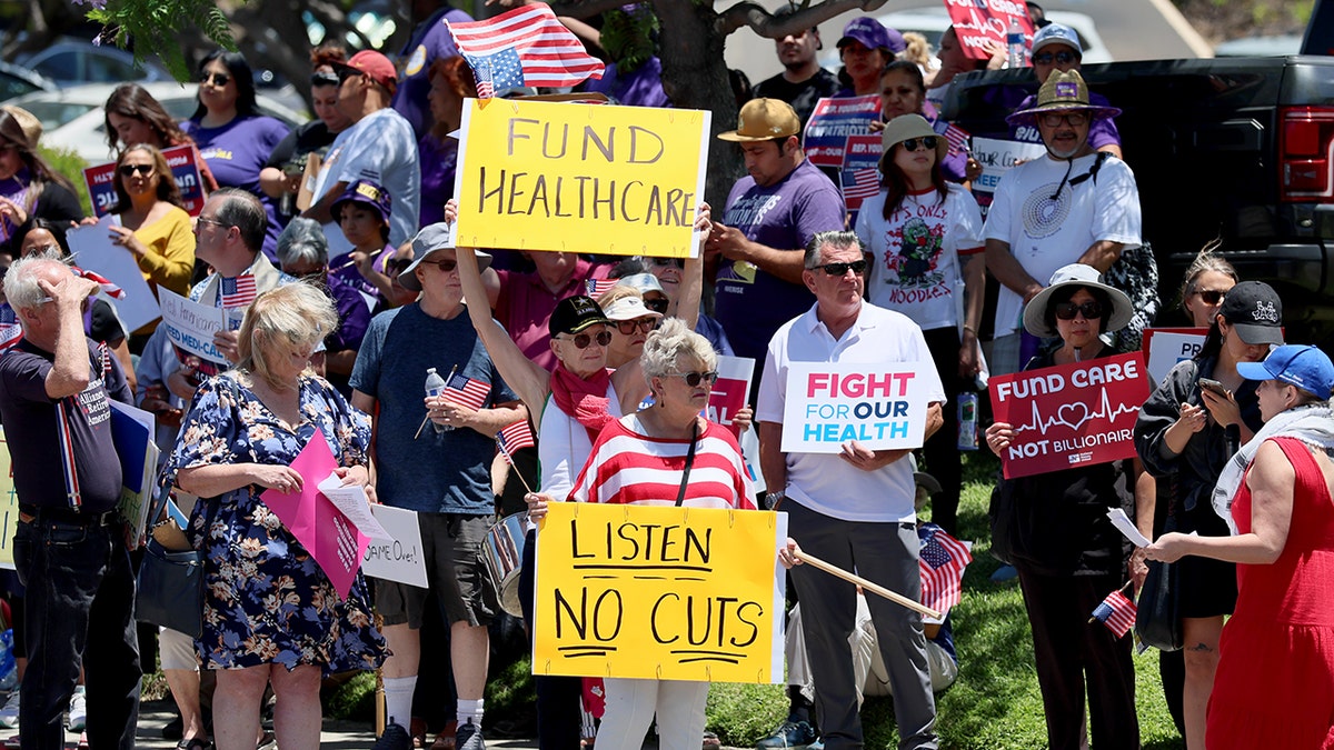 protesters holding signs