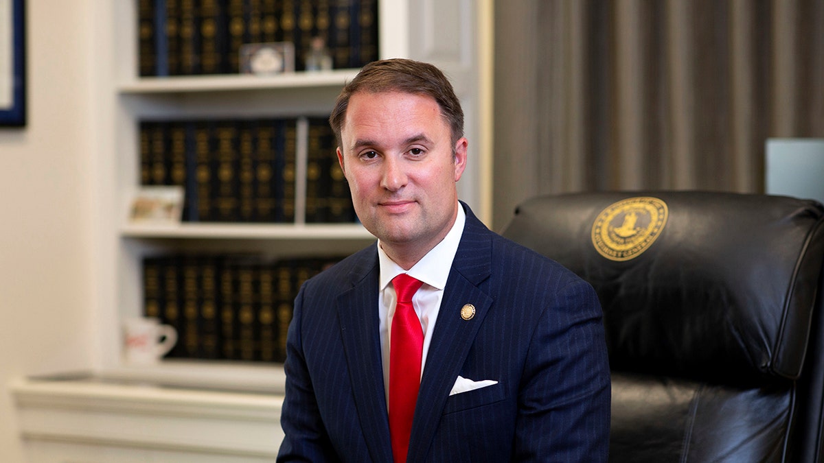 VA AG Jason Miyares poses for a photo in office