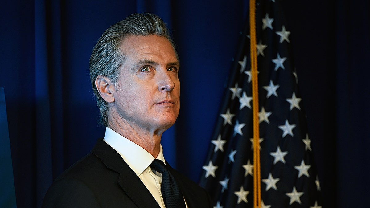 Governor Newsom looks to the ceiling during press conference