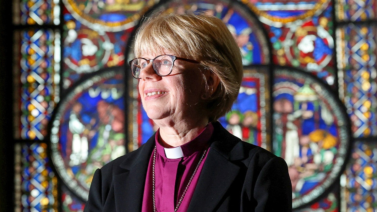Archbishop of Canterbury-designate Sarah Mullally stands in front of stained glass