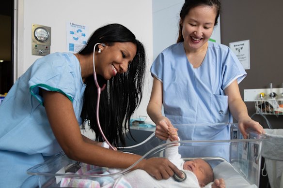Obstetricians Kaushi Arulpragasam and Stephanie Sii with baby Richie Hicks at the Royal Hospital for Women in Randwick, Sydney, in 2021.