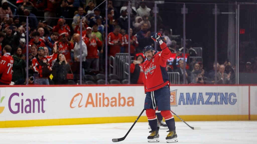 Alex Ovechkin becomes first NHL player to reach 900 goals as opposing goalie tries to hide milestone puck