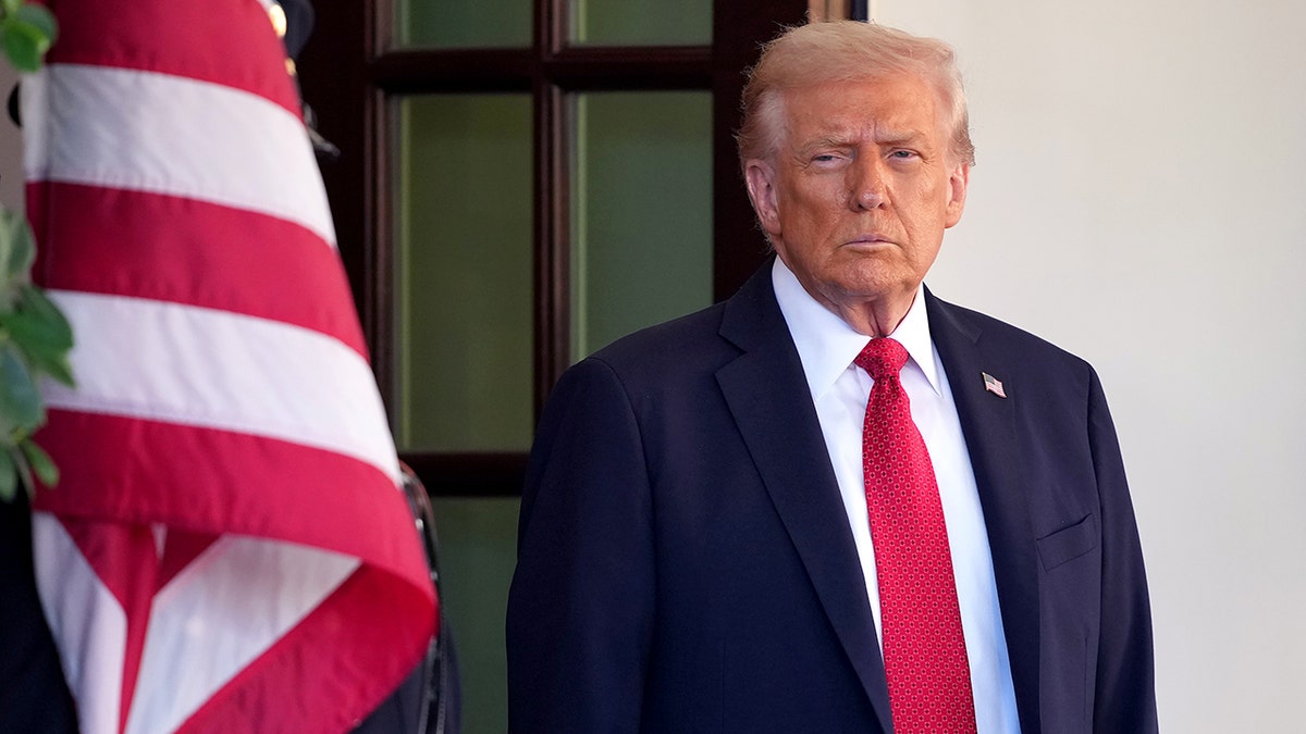 President Donald Trump waiting outside the White House.