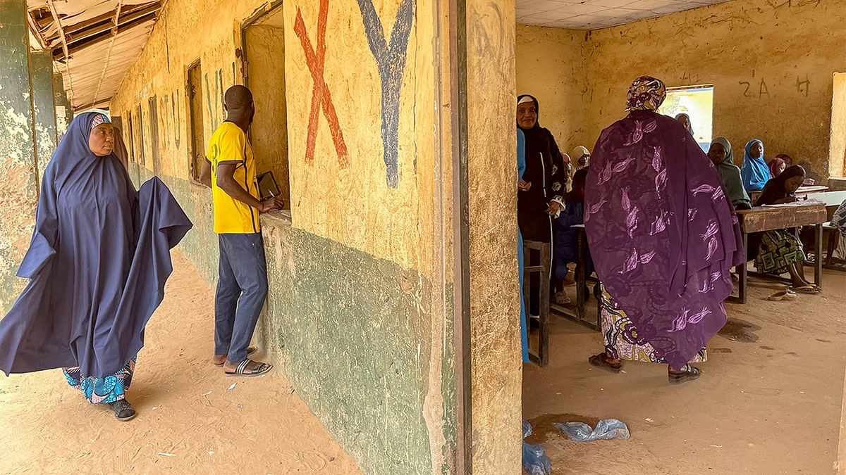 A woman walks past a classroom in northern Nigeria.