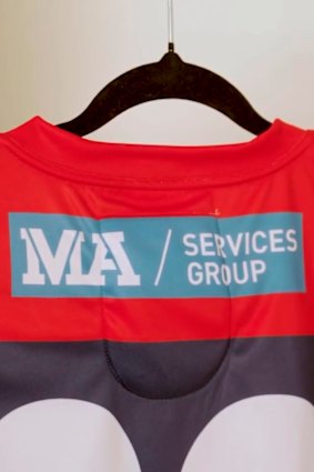 MA Services’ logo on the back of a Melbourne Demons guernsey.