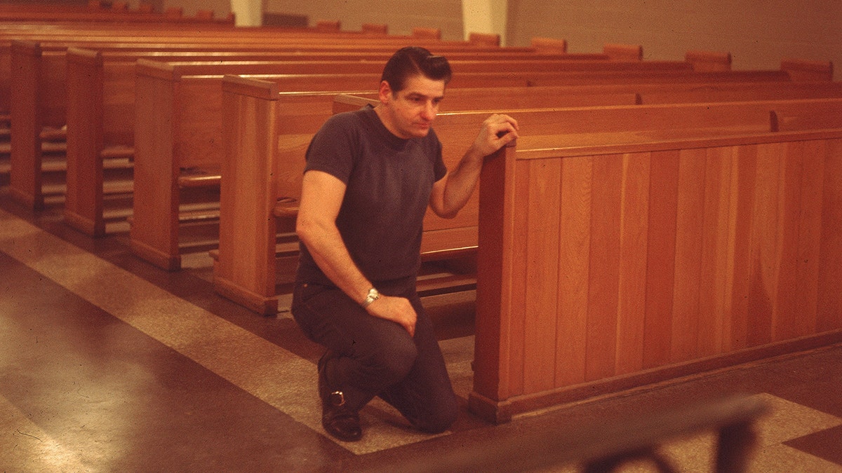 Albert DeSalvo kneeling in church.