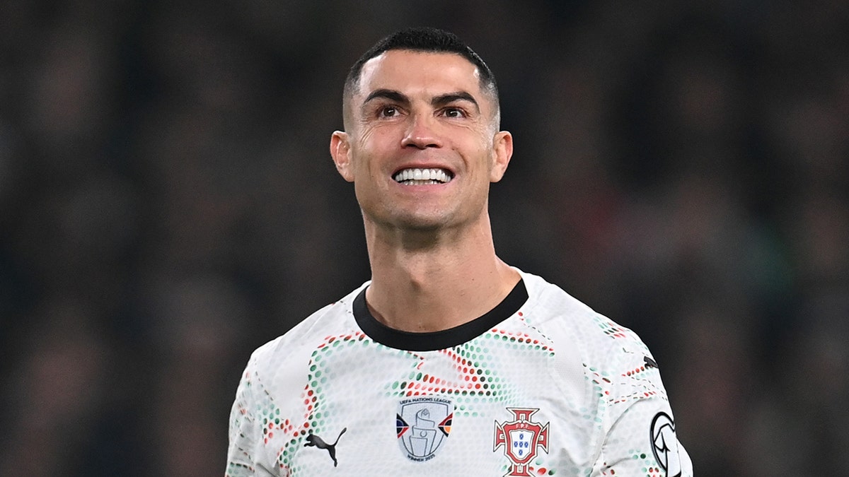 Cristiano Ronaldo smiles on soccer pitch