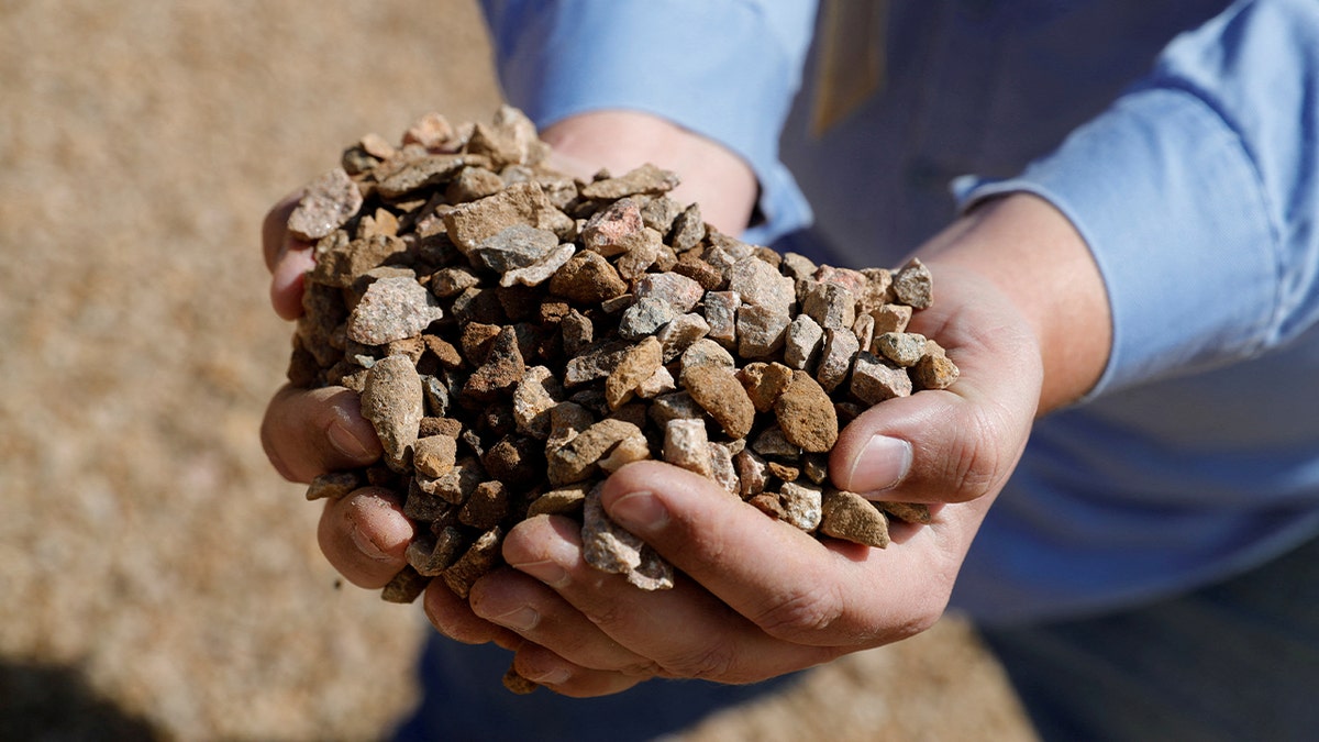 Matt Green, mining/crushing supervisor at MP Materials, displays crushed ore before it is sent to the mill at the MP Materials rare earth mine in Mountain Pass, California