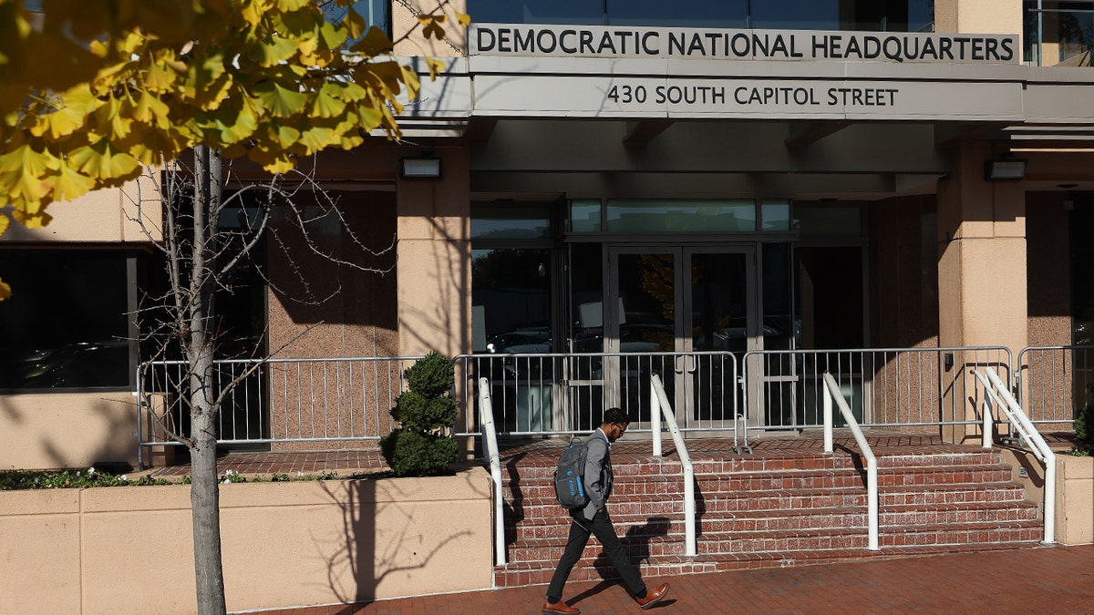Man walks past the Democratic National Committee headquarters in DC.