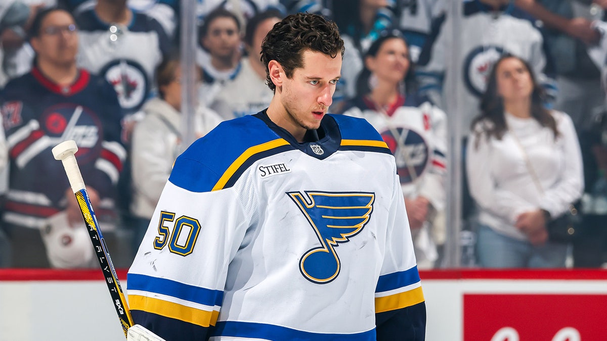 Jordan Binnington looks on before an NHL game starts