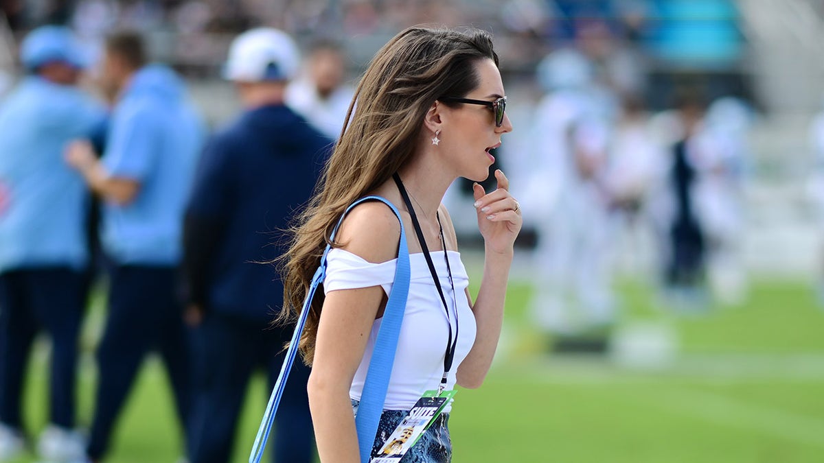Jordon Hudson walks on field before game
