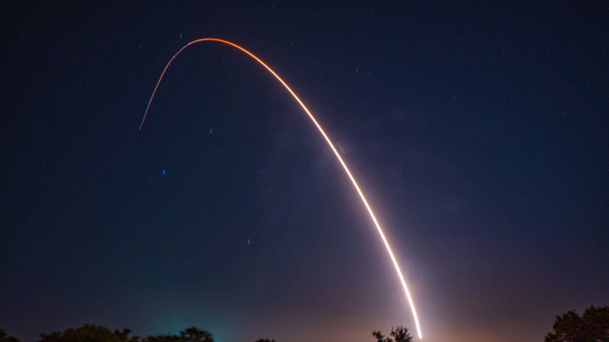 ICBM missile arc against night sky